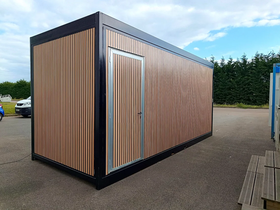 Bureau modulaire habillé par ModulSkin d'un bardage effet bois à lames verticales, encadrement anthracite